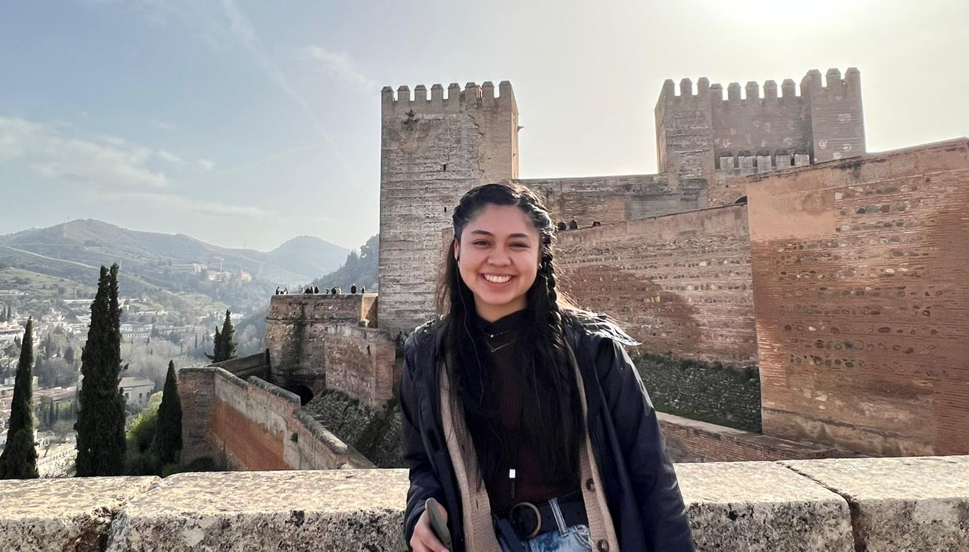 Student standing in front of castle in Spain