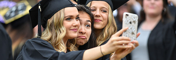 3 students taking a selfie at commencement