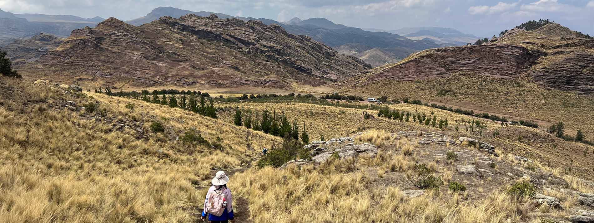 a girl looking at a mountainscape