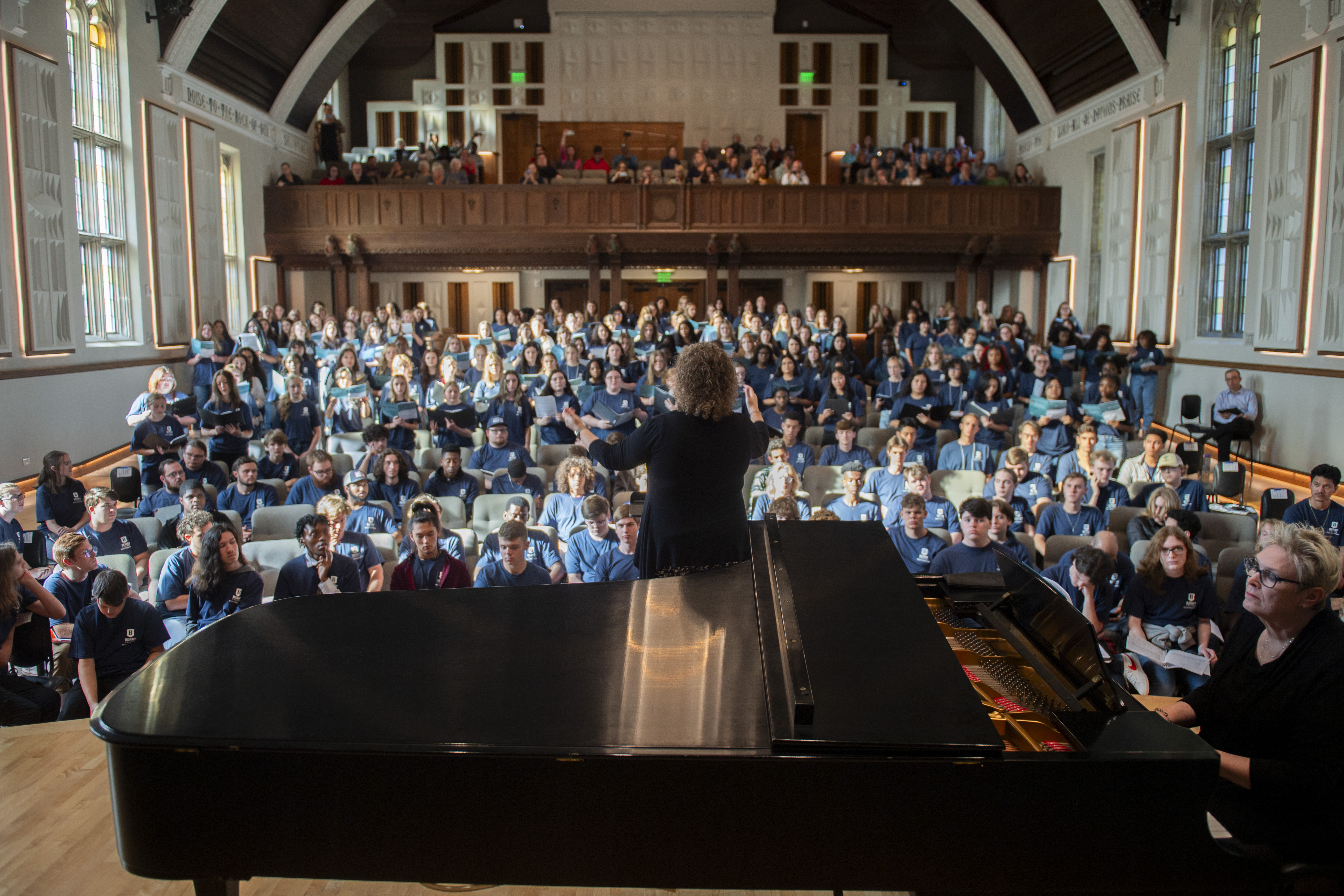 conductor in front of a large group of singers