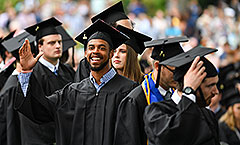 Student waving at commencement
