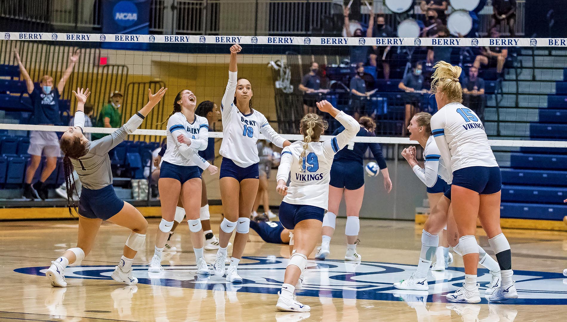 Berry College Volleyball Team celebrating on the court