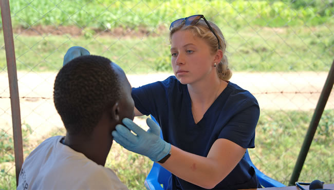 Nursing student treating a patient in Kenya during a summer program.