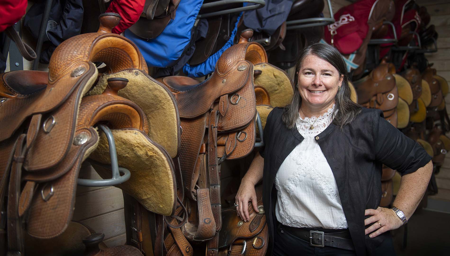 Meghan Nolan Boenig in front of a saddle