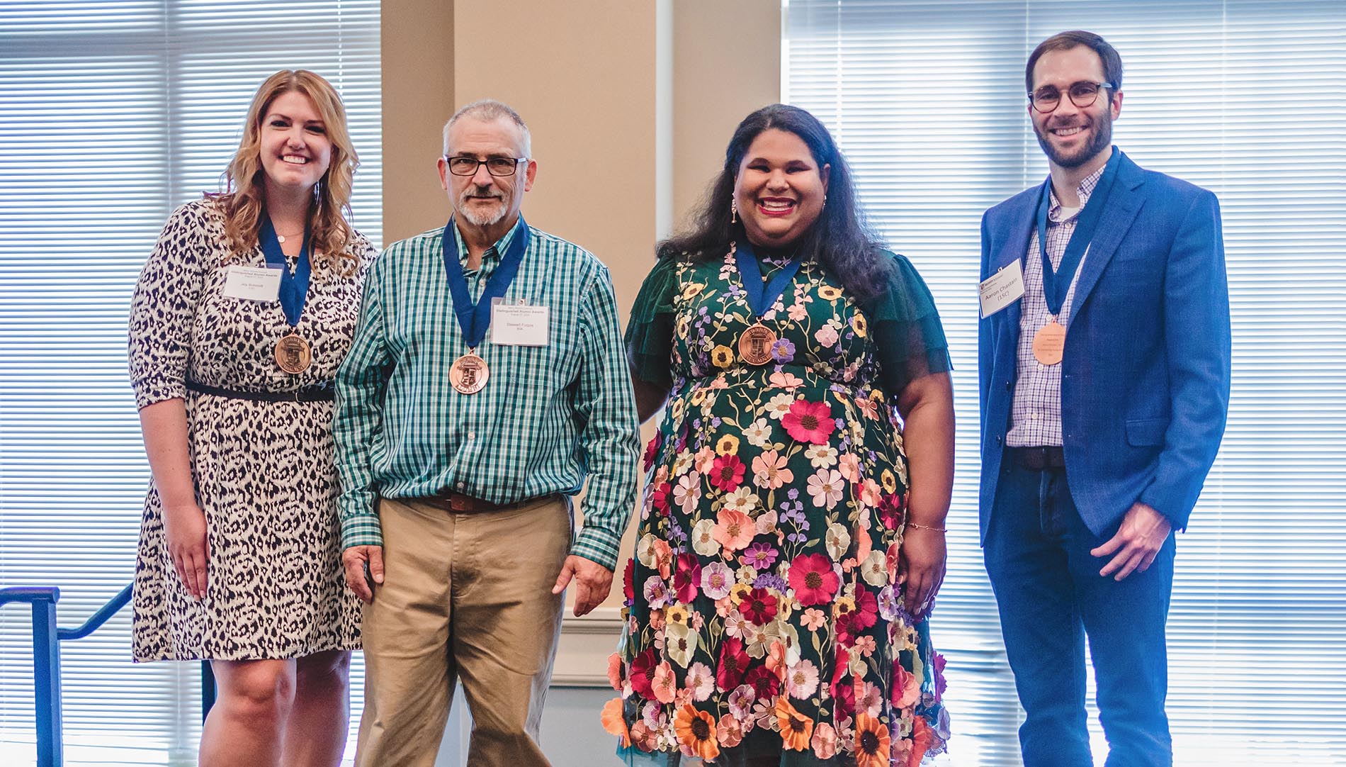 Genny Castillo, Aaron Chastain, Stewart Fuqua and Joy Schmidt wearing medals