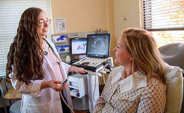 Dr. Katie Edenfield Price standing in exam room.