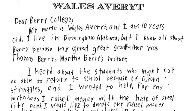 Male student with popsicle next to Steel City Pops stand