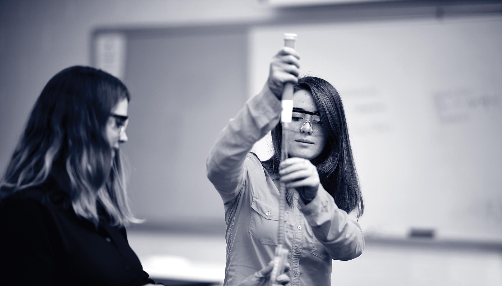 Students with a syringe in black and white