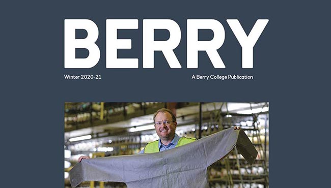 Victor the Viking mascot sewing large face masks