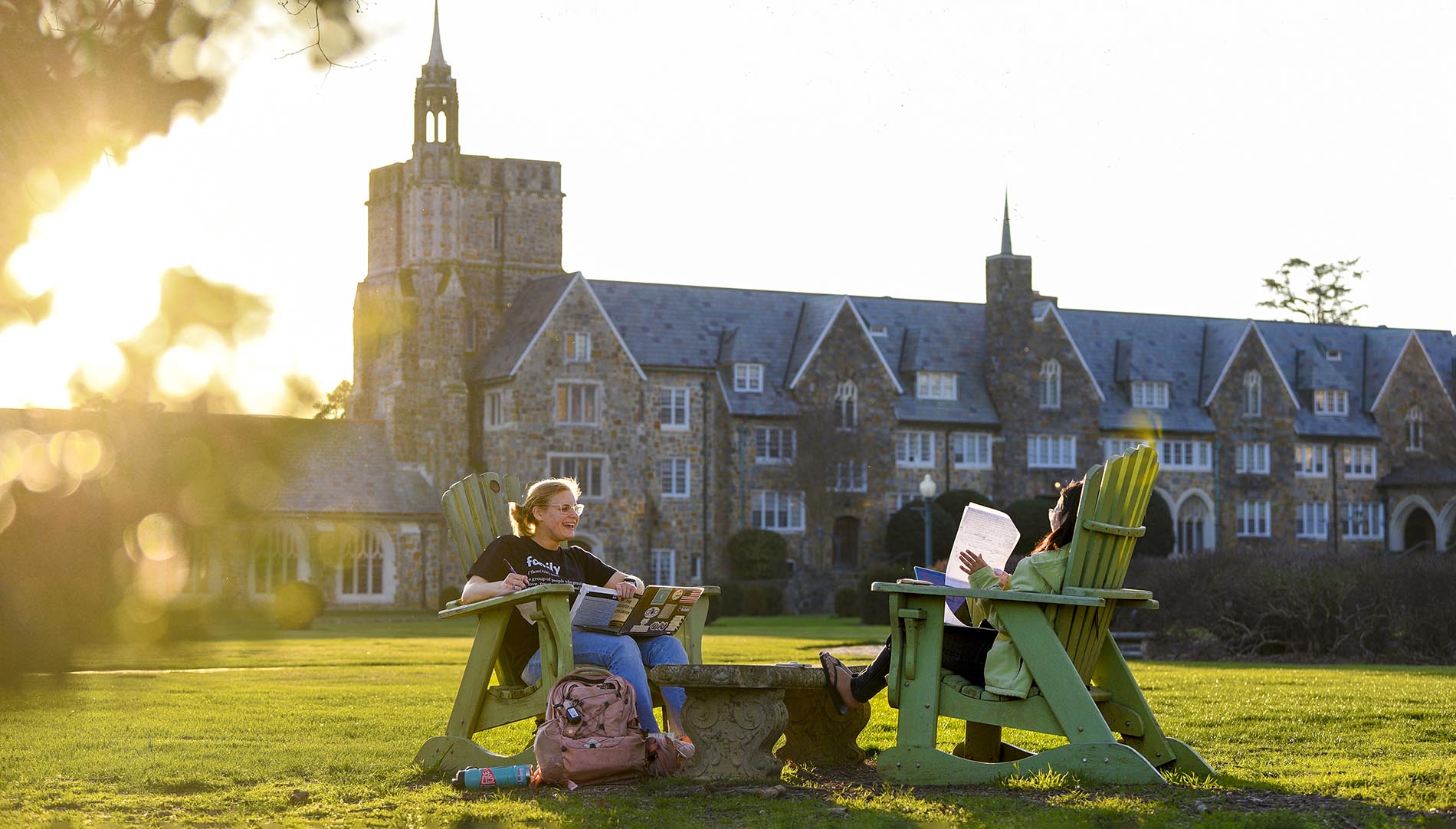 Students sitting on the lawn in front of Ford Building