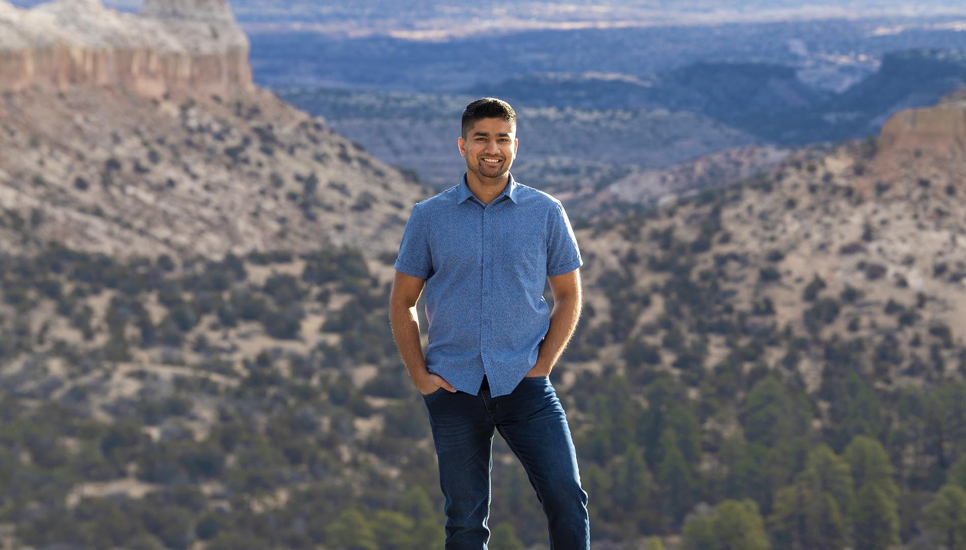 Vedant Mehta ona mountainside in the desert