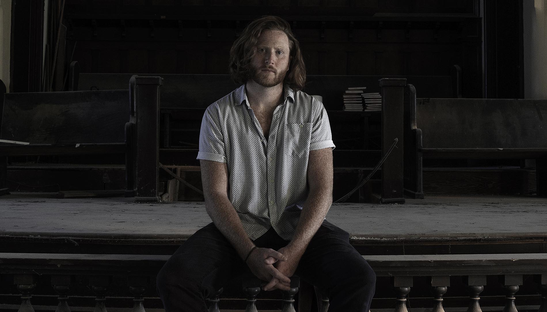 Campbell Harrison sitting on a stage