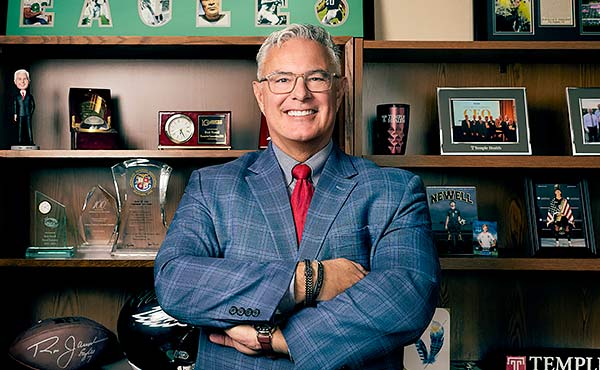 Danielle Cain working with a fellow nurse with a transparent image of her working with a patient in the background.