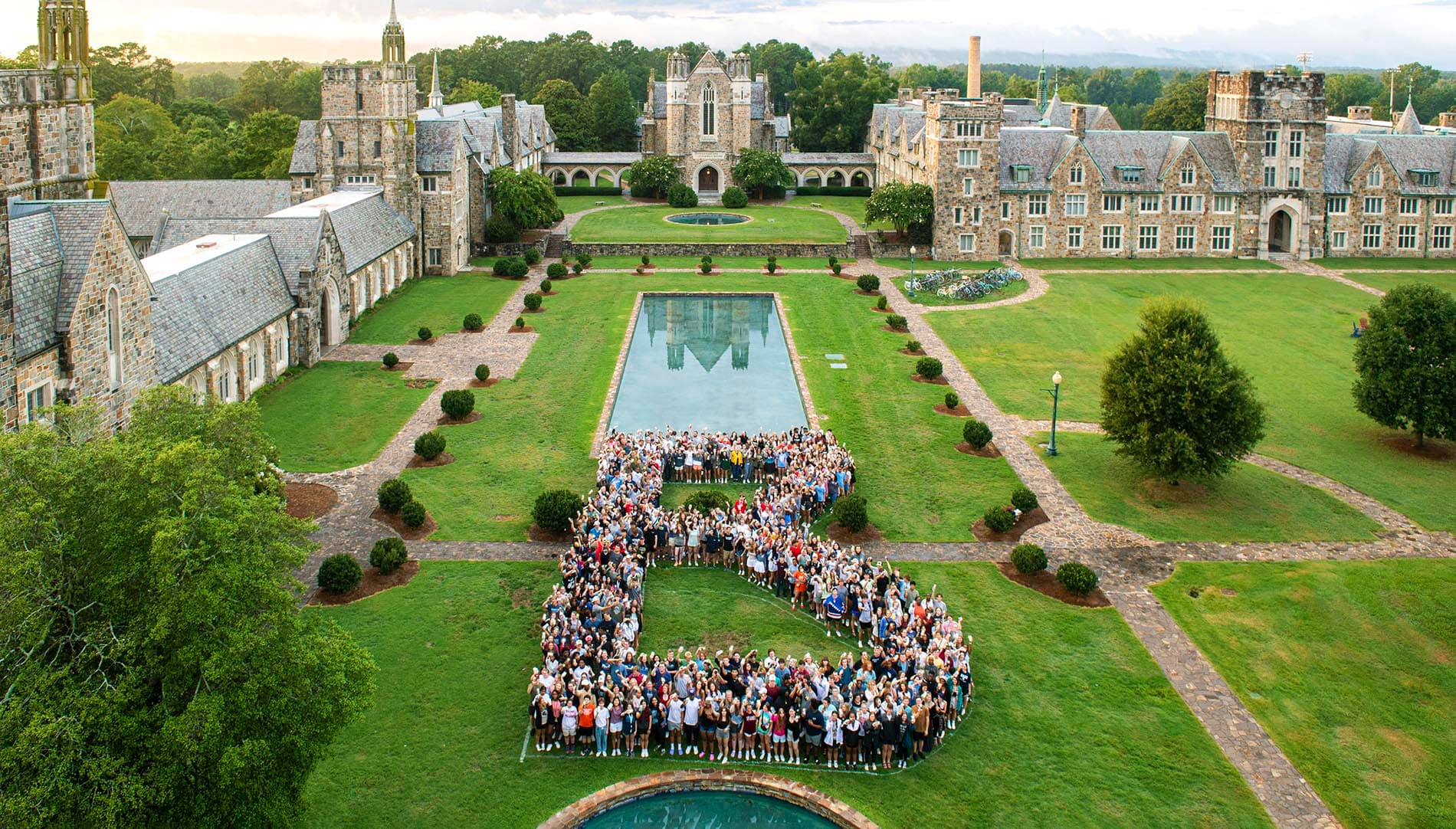 Overhead shot of students standing on the lawn in the shape of a B.