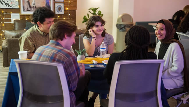 Group of guys laughing on a slip n slide