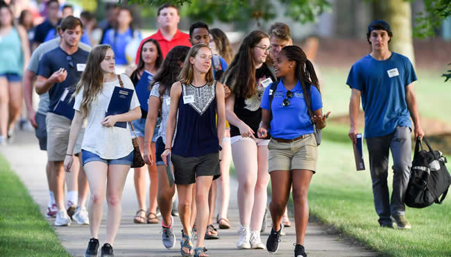 Orientation leader escorting students around campus