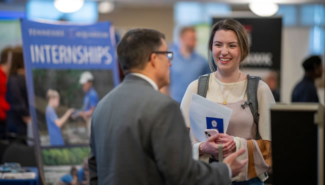 student at networking event for internships
