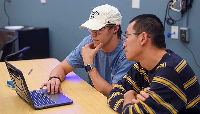 students wading in a creek with nets