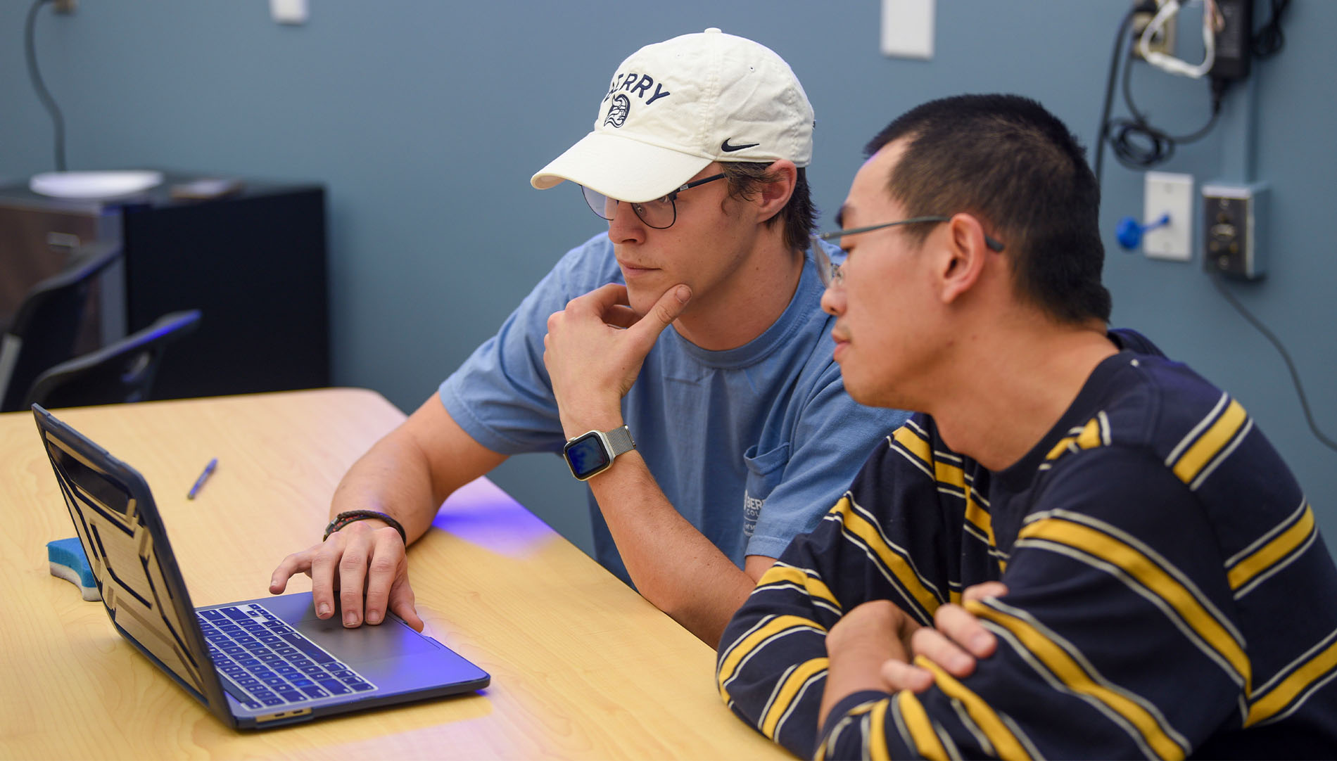 students wading in a creek with nets