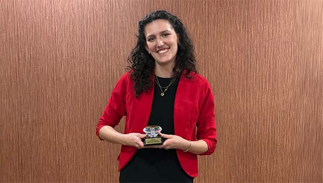 Emma Zaworski holding a plaque