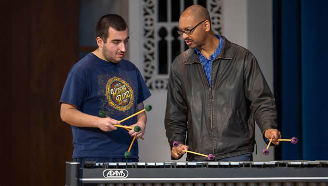Jason Marsalis and student Ryan Aldridge play percussion instruments