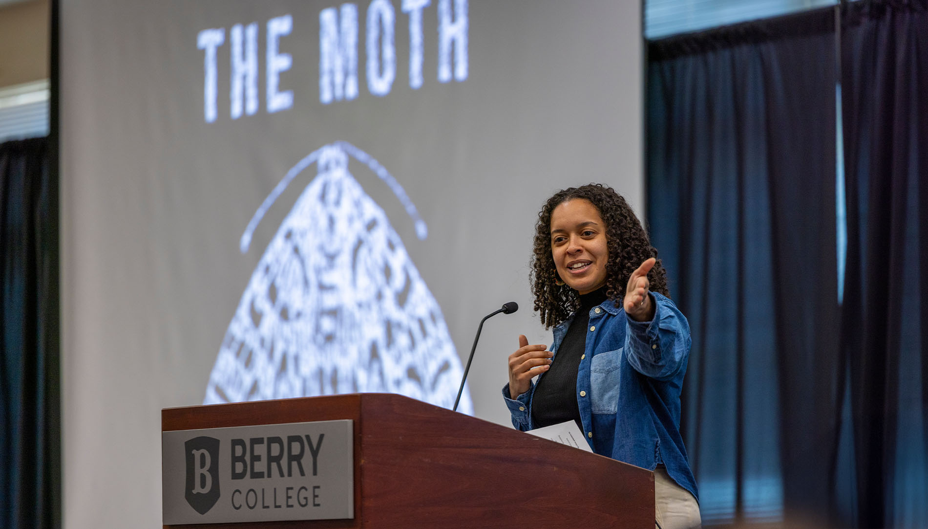 Author presenting on stage