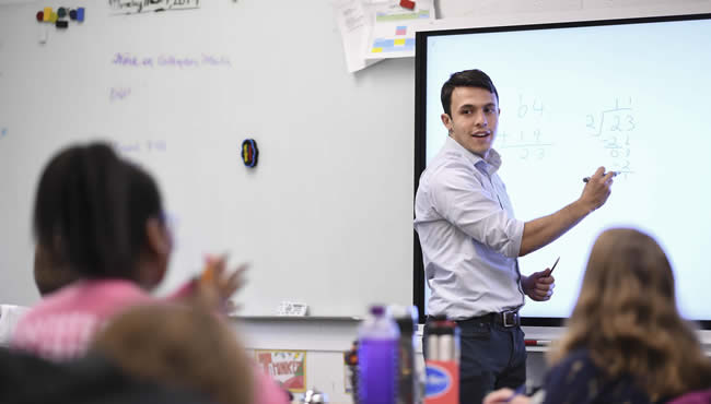 Alex Perry writing on a smart board