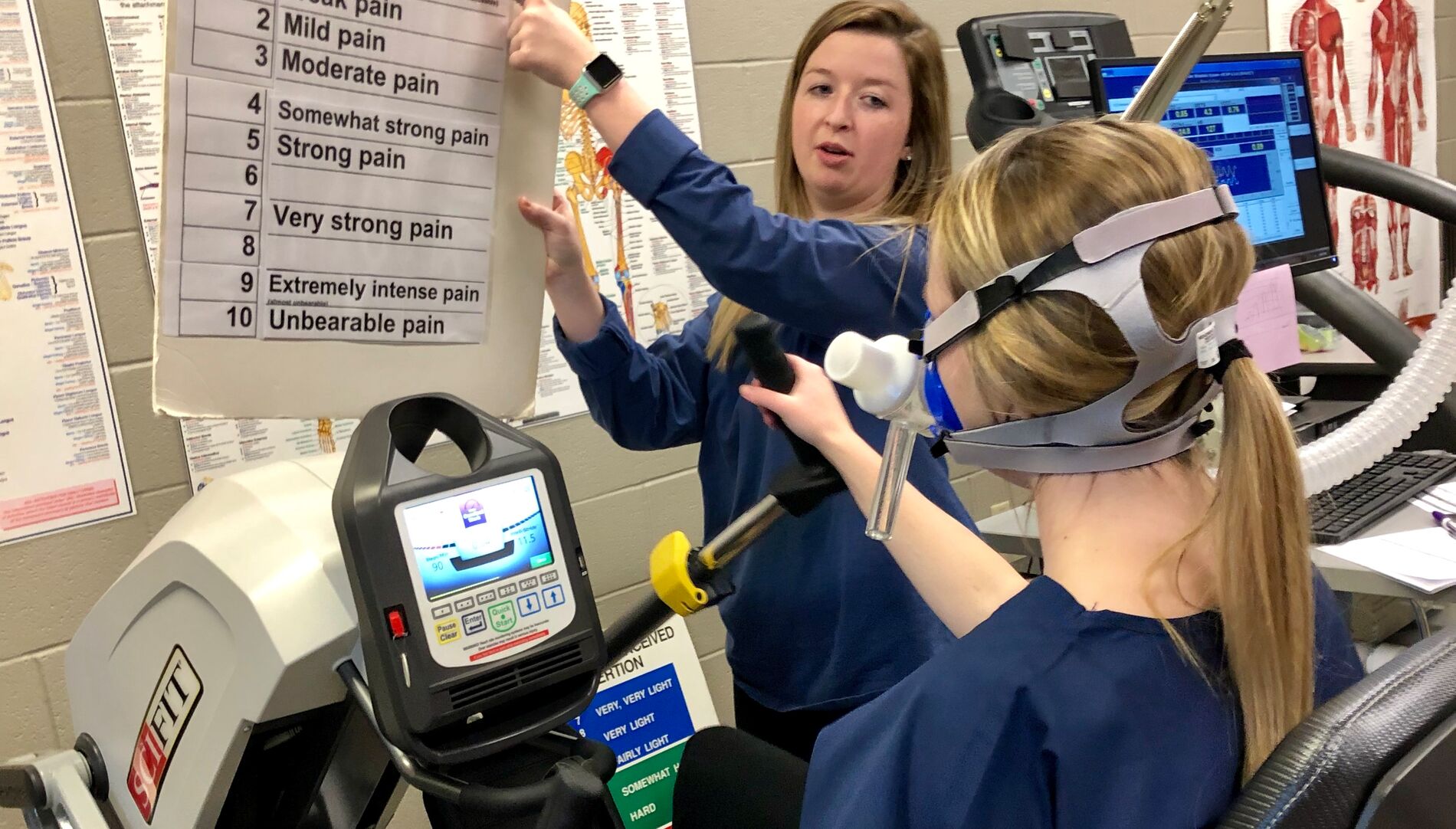 Nursing student holding a pain chart