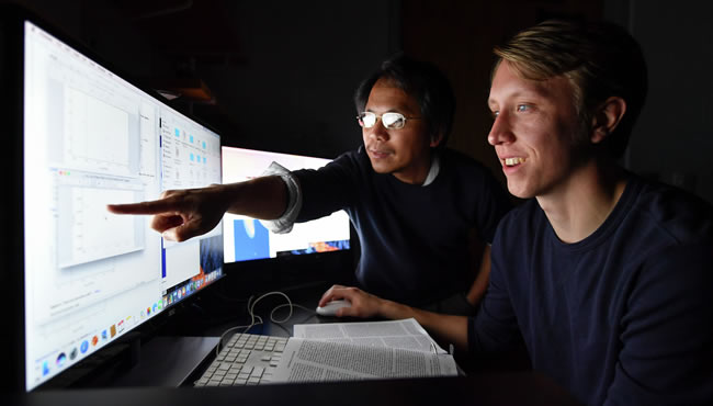 Professor and student at a monitor