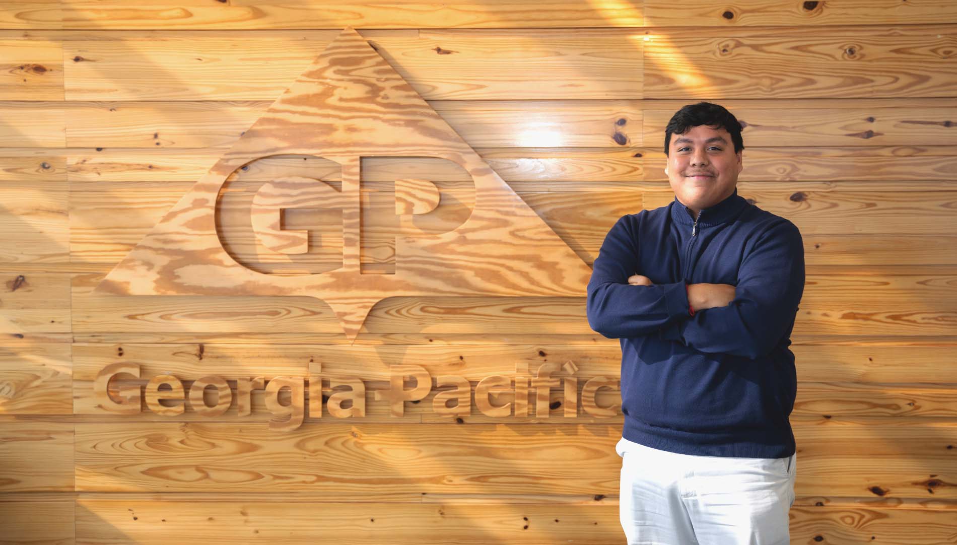 Wesley Romero standing in front of Georgia Pacific logo