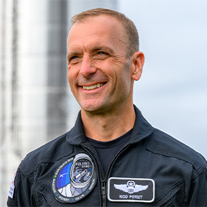 Scott "Kidd" Proteet smiling while wearing a flight suit