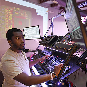 student producing music in creative technologies lab